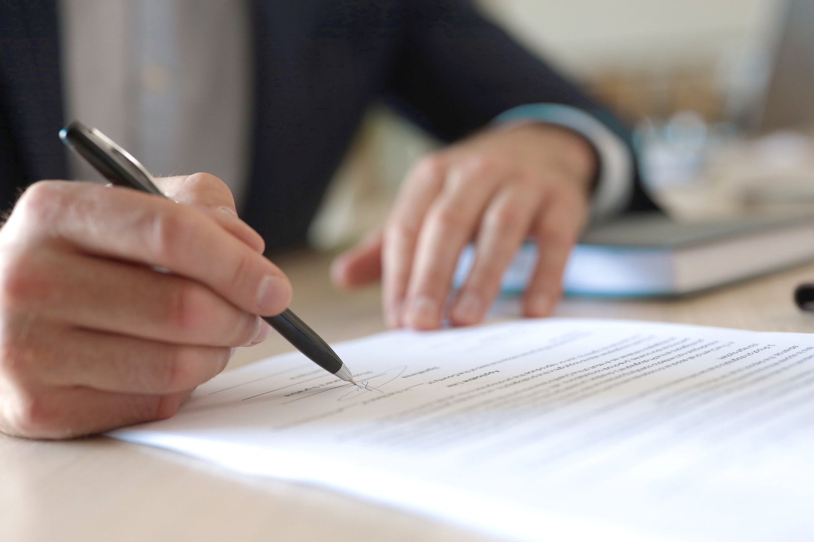 A hand marking up a printed score with a pencil