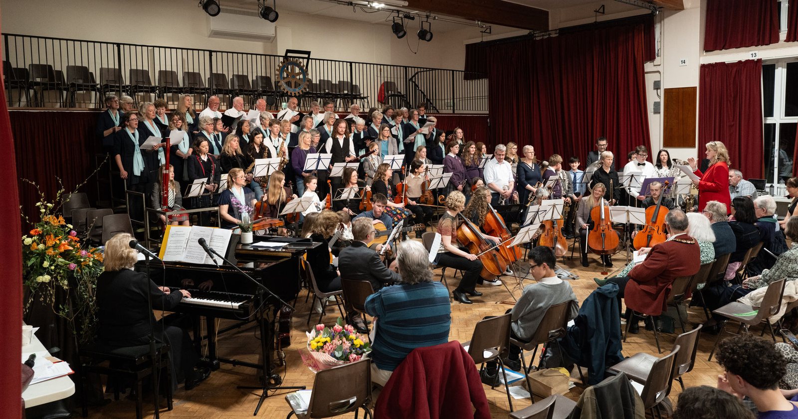 A full choir and orchestra performing to a packed hall