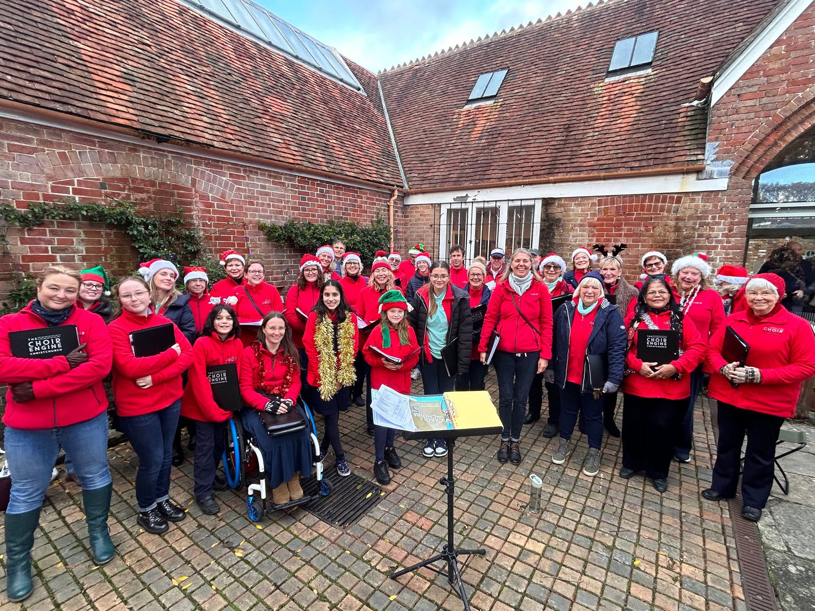 The choir in red concert shirts gathered outside before a performance