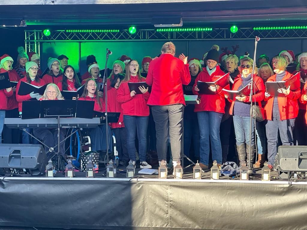 The choir performing on a lit stage