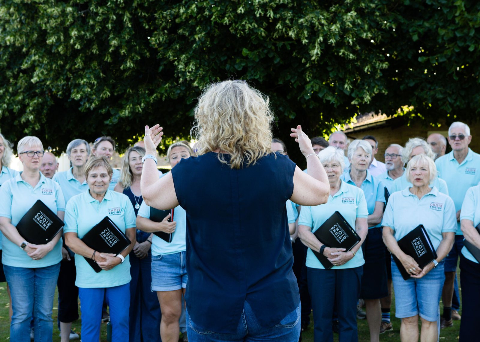 Caroline rehearsing with the choir outdoors