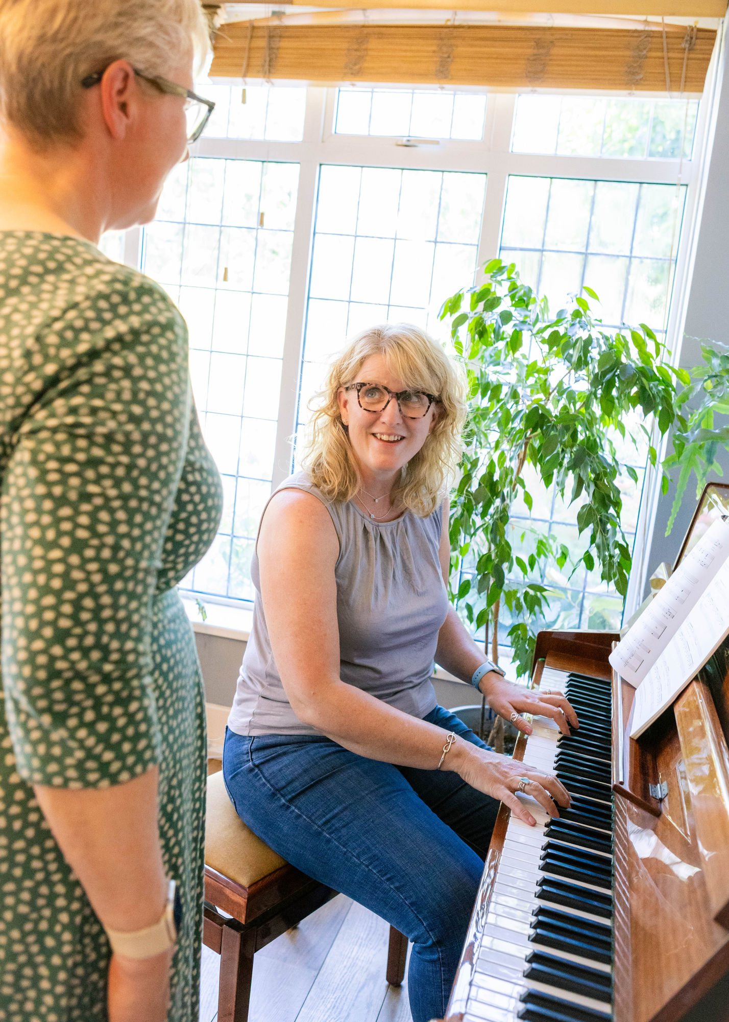 Caroline accompanying at the piano
