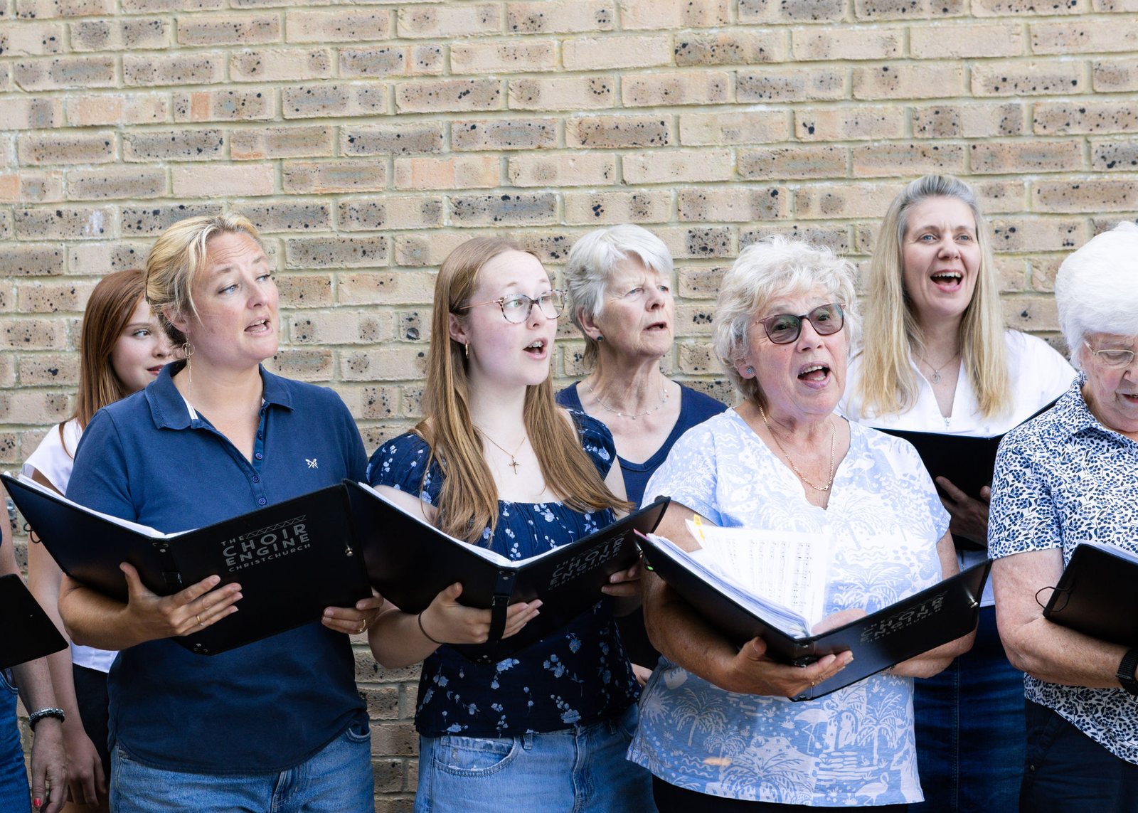 Singers sharing a folder, mid-phrase
